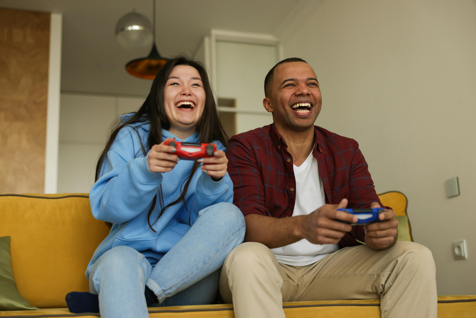 A man and woman playing video games together.