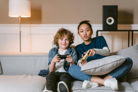 A woman and boy playing video games together.