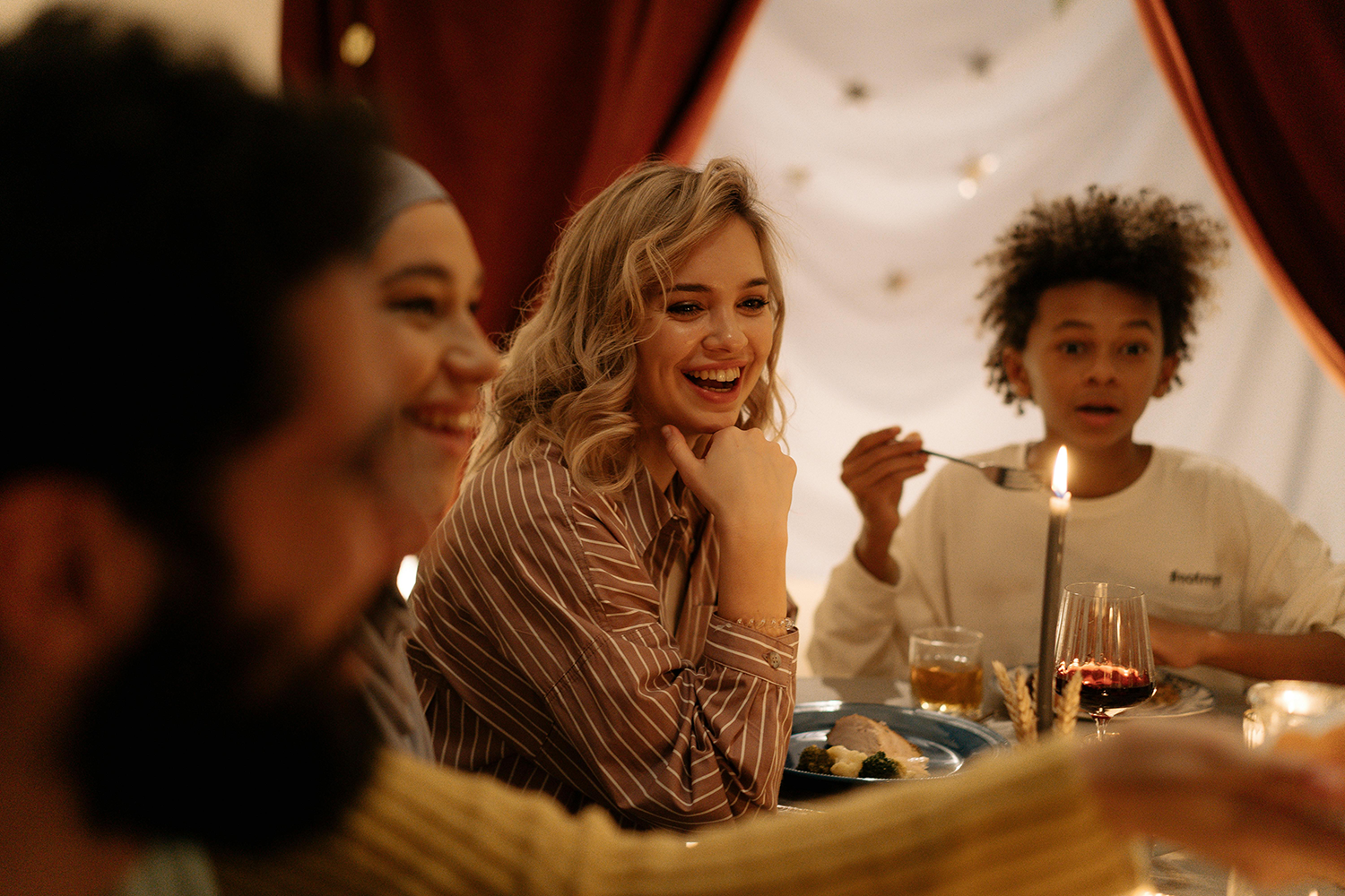 A person decorating the fall dinner table.