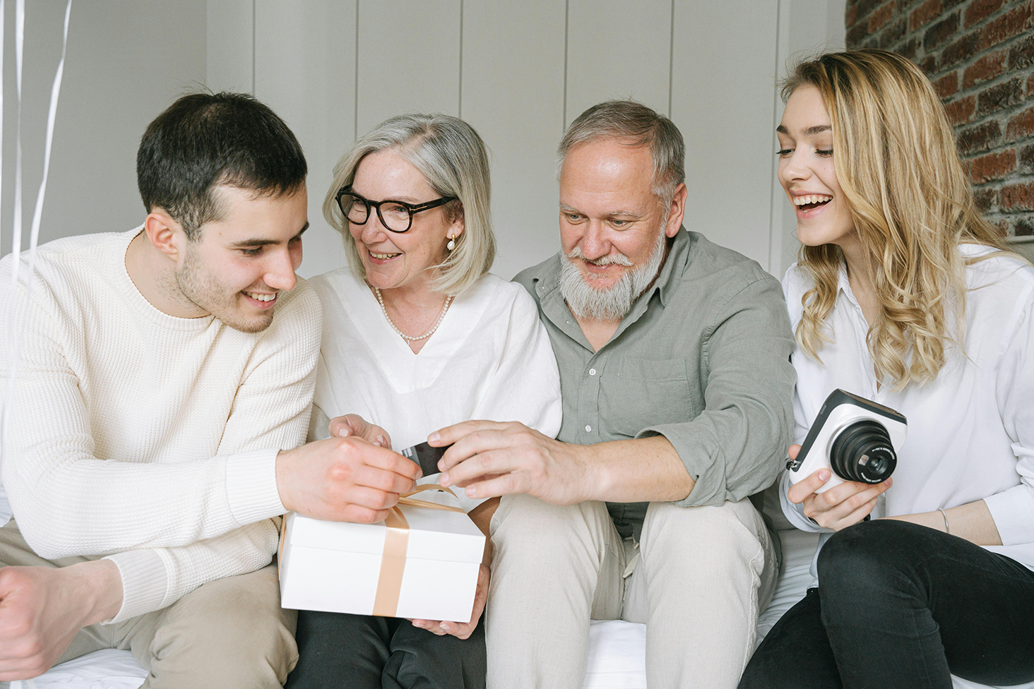 A young family giving gifts to in-laws.