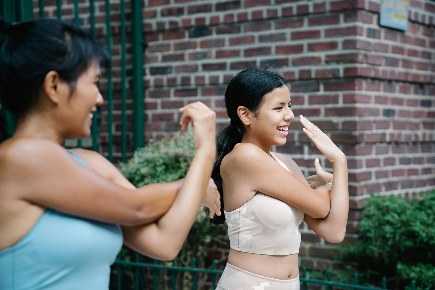 A mom and daughter doing their workout routine together.