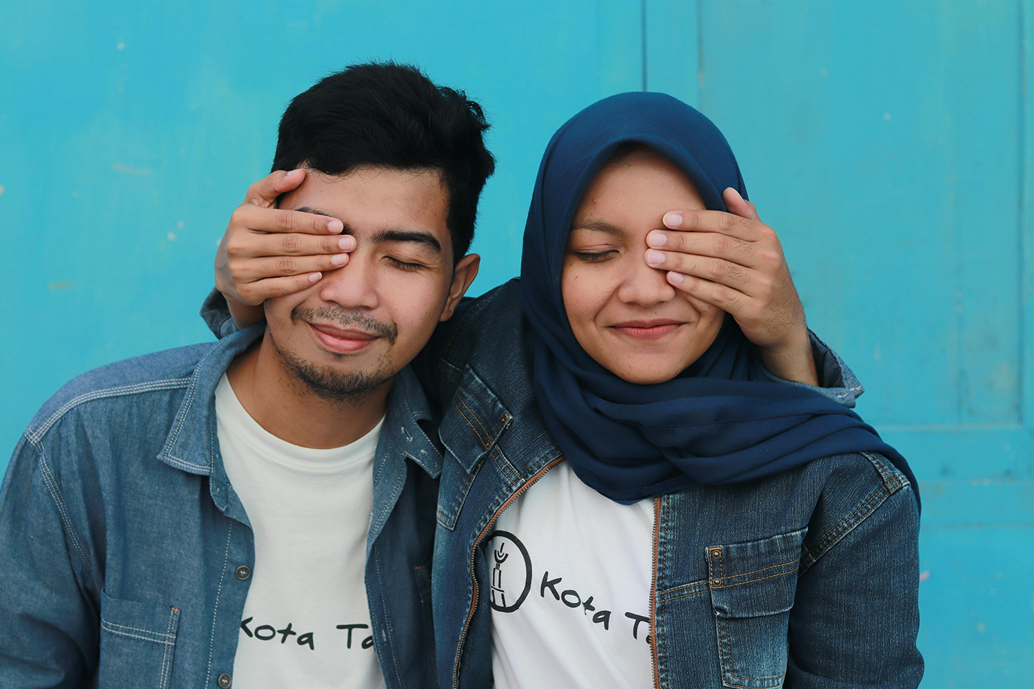 A couple wearing matching outfits and covering one of each other’s eyes. Marriage and Individuality: Setting Boundaries to Be Your Own Person.