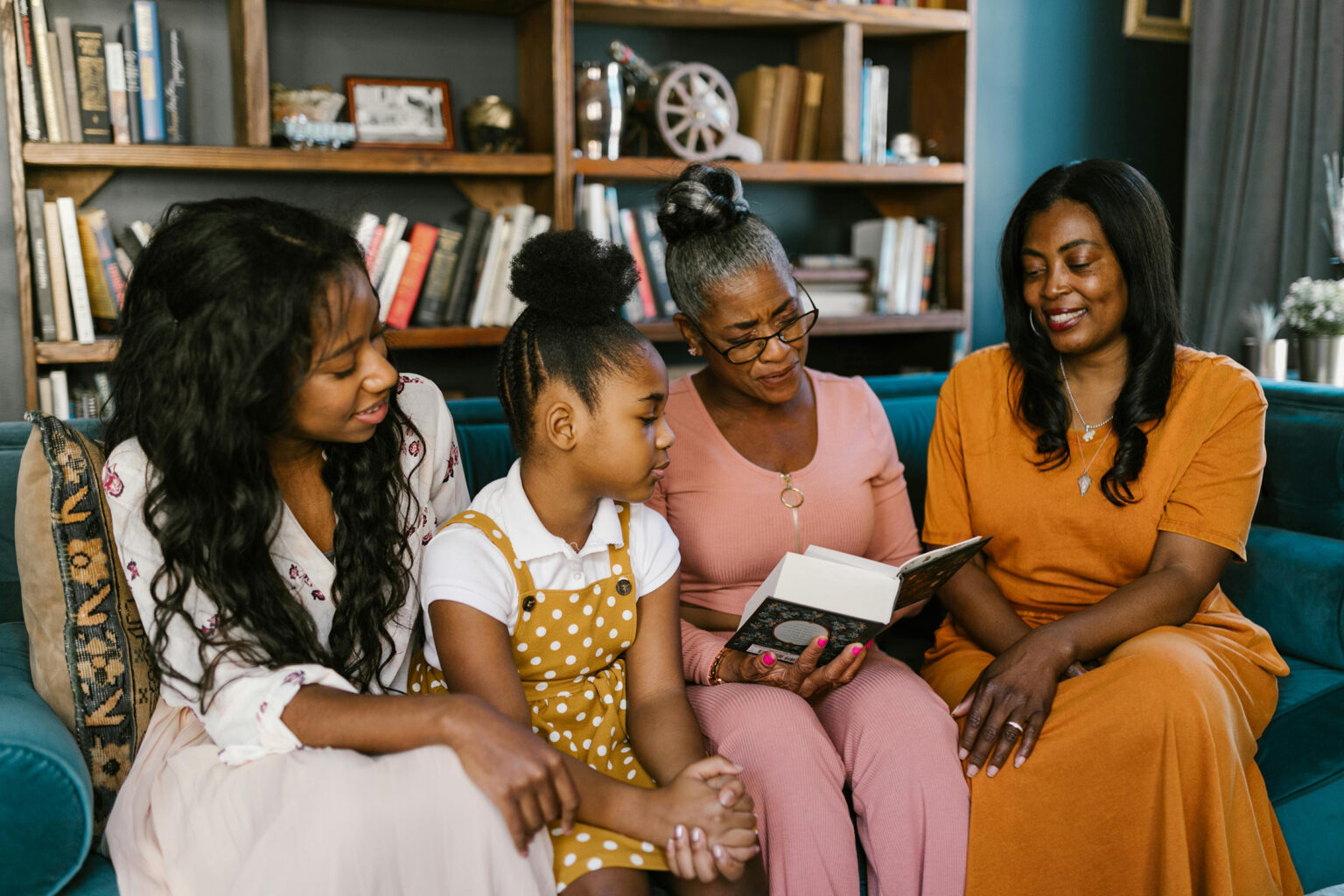 A group of daughters giving a letter to Mom.