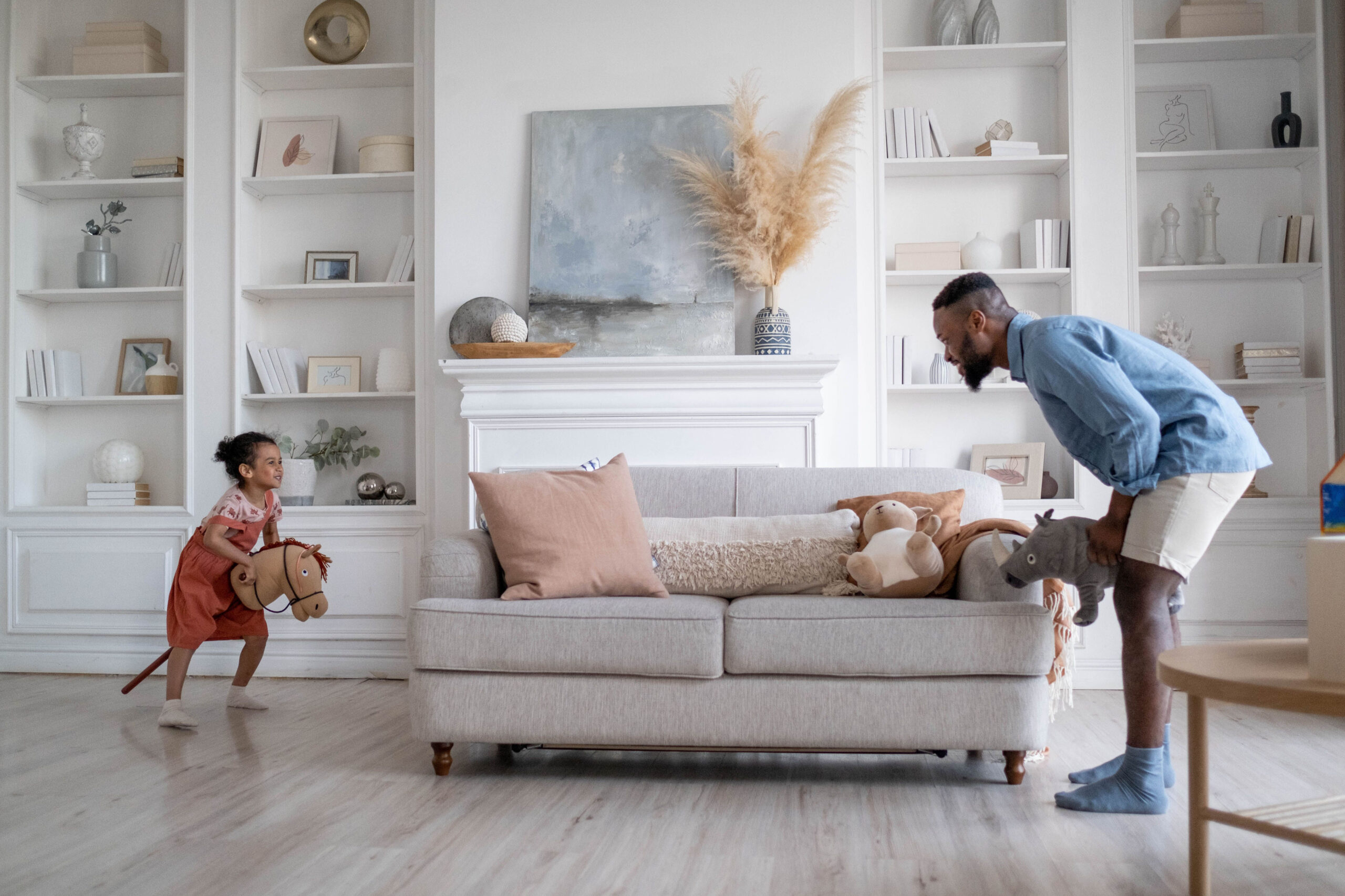 A father and child playing together next to a couch
