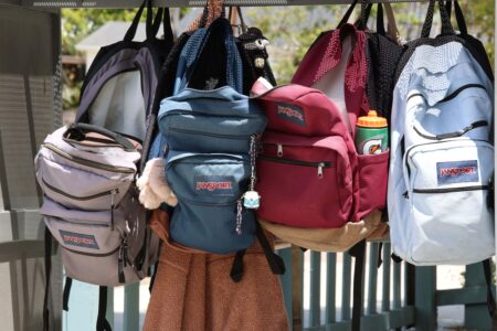 Four backpacks hanging outside